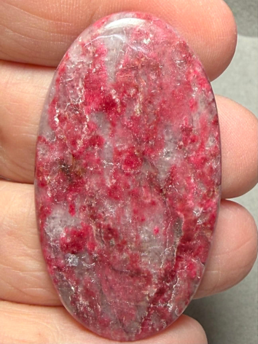 Oval 48x27mm Thulite Cabochon 83